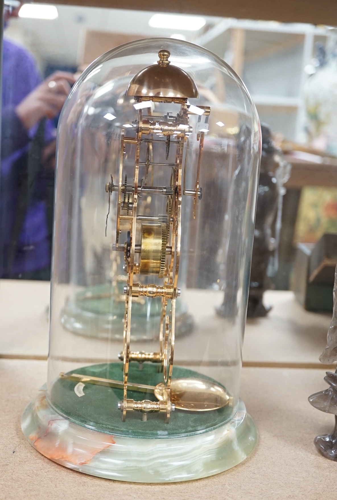 A Thwaites & Reed brass skeleton clock under dome, on onyx base, 27cm. Condition - good, not tested